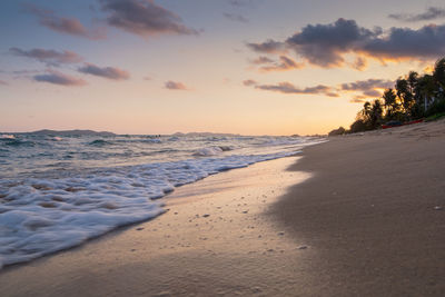 Scenic view of beach against sky during sunset