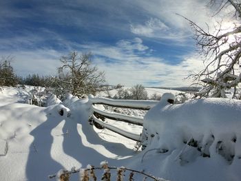 Snow covered field against sky