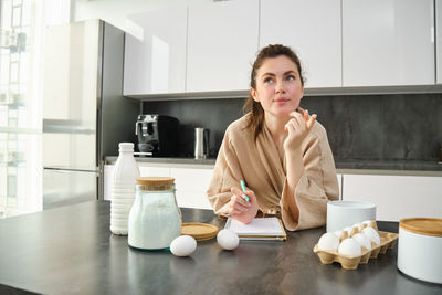 Young woman using mobile phone at home