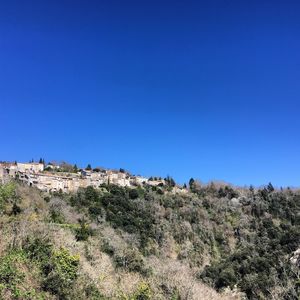 Scenic view of mountains against clear blue sky