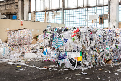 Stack of garbage can against built structure