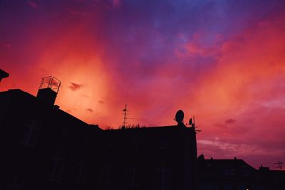 Silhouette of building against cloudy sky