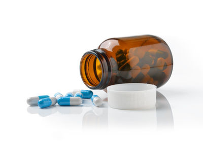 Close-up of medicine bottle against white background