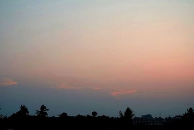 Low angle view of silhouette trees against romantic sky