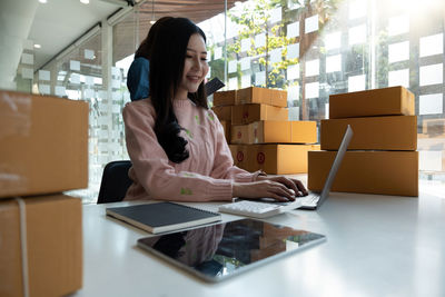 Young woman using laptop on table