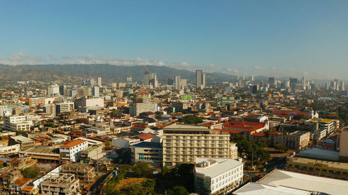 High angle view of buildings in city against clear sky