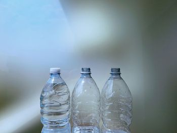 Close-up of bottles against gray background