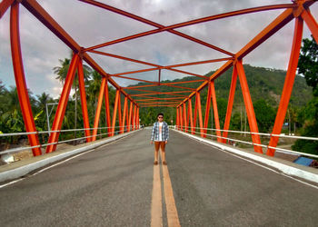 Rear view of man on bridge against sky