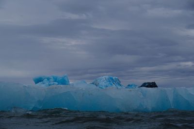 Scenic view of glaciers against sky during winter