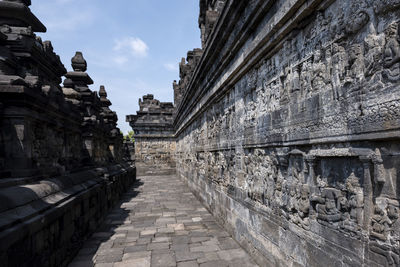 Corridor of historic building against sky