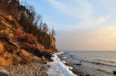 Scenic view of sea against cloudy sky