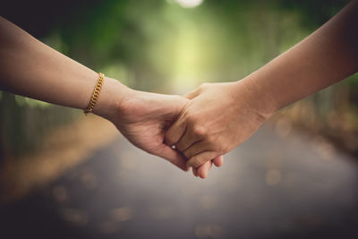Close-up of couple holding hands