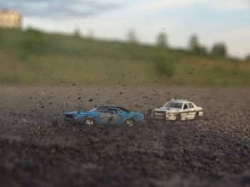 Remote controlled cars on dirt road