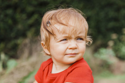 Cute baby girl looking away outdoors