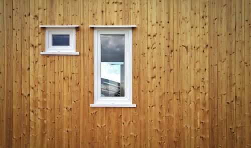 Windows on wooden wall