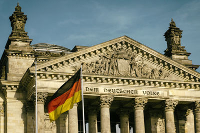 German flag waving against reichstag building