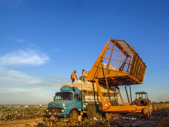 Construction site on field against blue sky