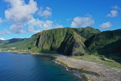 Scenic view of sea and mountains against sky