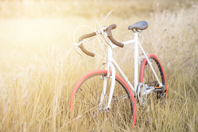 Bicycle on grassy field against sky