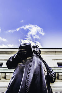 Low angle view of statue against blue sky