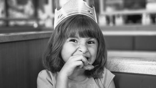 Close-up portrait of girl eating food outdoors