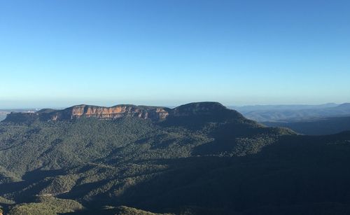 Scenic view of dramatic landscape against clear blue sky