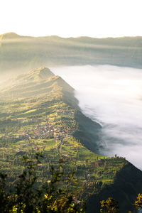 Scenic view of sea and mountains against sky