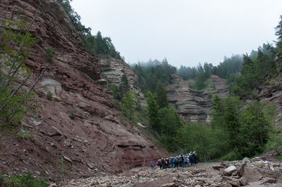 People on mountain road against sky