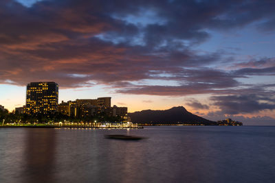 Sunrise over waikiki beach with an outrigger