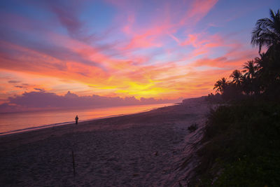 Scenic view of beach against sky during sunset