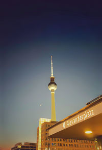 Berlin tv tower, a beautiful view from alexanderplatz, together with moon.