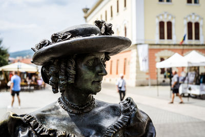 Close-up of statue against city street