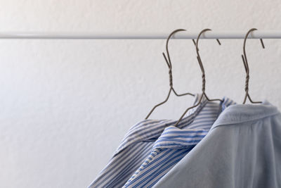 Clothes on hangers, blue shirts on a white background, shopping, clothes wardrobe