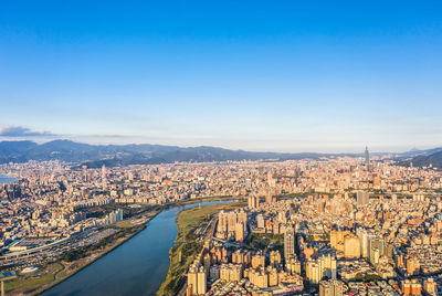 High angle view of city against blue sky