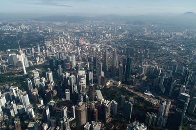 Aerial view of modern buildings in city against sky