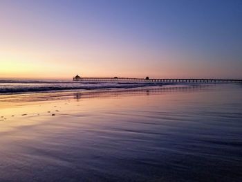 Scenic view of sea against clear sky during sunset