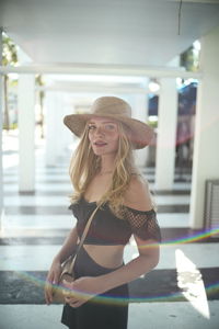 Portrait of young woman wearing hat