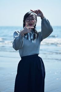 Side view of woman standing at beach