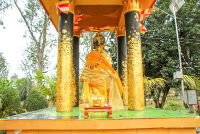 Statue of buddha against trees