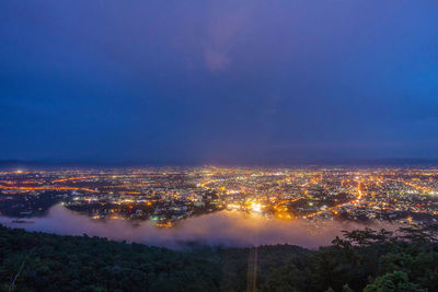 Aerial view of cityscape against sky at night