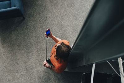 High angle view of woman sitting on seat