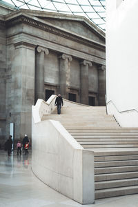 People walking on staircase of building