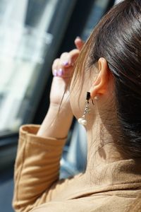 Cropped image of woman wearing earring