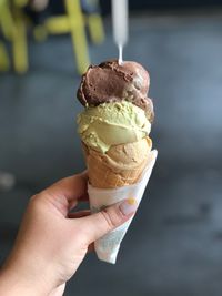 Close-up of hand holding ice cream cone