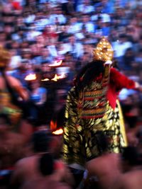 Rear view of people walking at illuminated temple