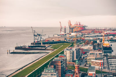 High angle view of commercial dock by sea against sky