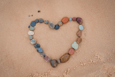 High angle view of heart shape on sand