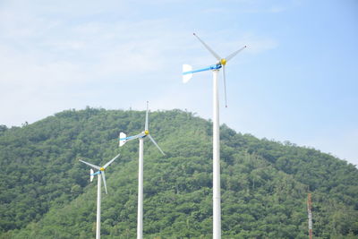 Windmill on field against sky