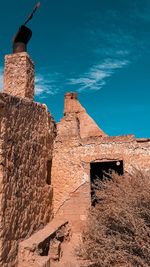 Low angle view of old building against blue sky