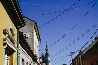 Low angle view of buildings against blue sky